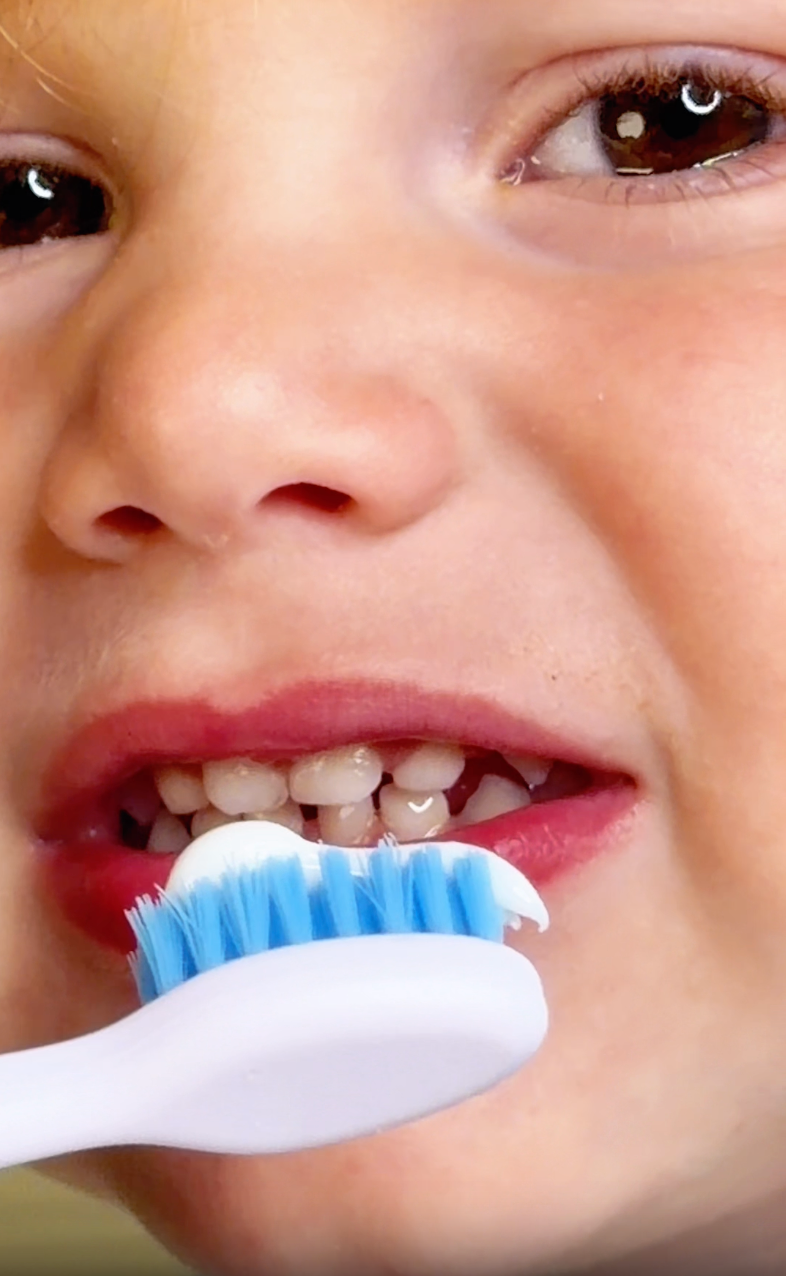 Kid brushing teeth with Cheez toothpaste during daily routine